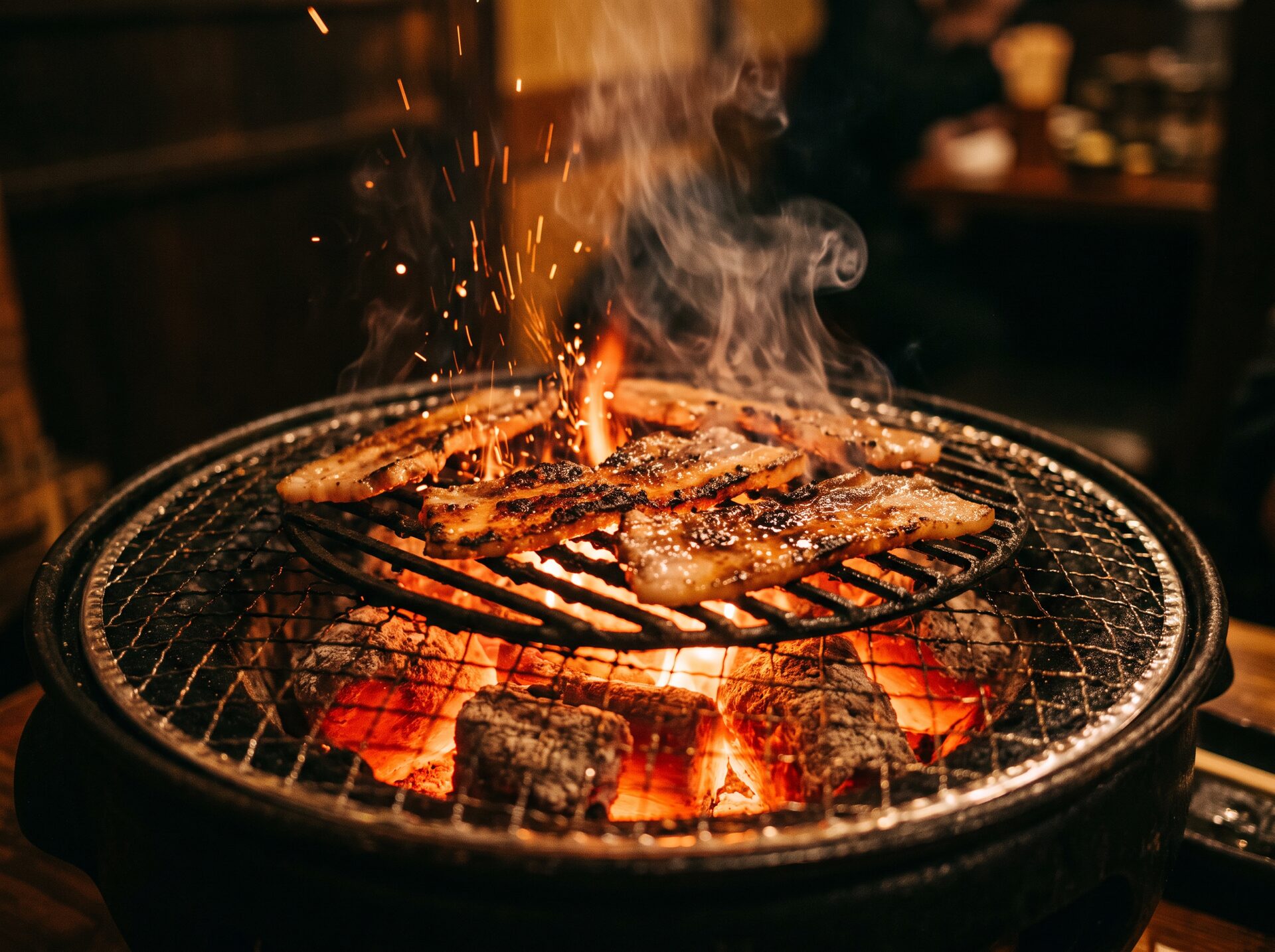 Pork belly searing over glowing binchotan charcoal